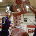 Stanwood&rsquo;s Nate Kummer is fouled as he goes up for a shot during a game against Lake Stevens on Tuesday in Stanwood. The Spartans won 74-51. (Andy Bronson / The Herald)