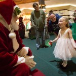 Khloe Gregory, 4, reacts with excitement with her parents, Matt Gregory and Khrysha Liska, while talking with Santa, 74-year-old Tom LaBelle, in the Everett Mall on Monday, Nov. 28. LaBelle began wearing the suit after his wife suggested he try it out. He&rsquo;s now a regular each year as a mall Santa and has an entire collection of answers about Santa&rsquo;s duties for his most inquisitive visitors. (Daniella Beccaria / The Herald)