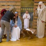 As visitors take photos, Suzanne Toolson fixes the hair of Mea Ruston, 15, as she sits in the live nativity at the fifth Nativity Festival in the Church of Jesus Christ of Latter-day Saints on Thursday in Arlington. The free event is open to the public and runs through the end of the weekend, finishing with a concert at 7 p.m. Sunday. (Andy Bronson / The Herald)