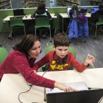Alexander Reed, 7, of Everett, and his mom, Yvonne, work through a computer coding program together at the &ldquo;Hour of Code&rdquo; event at the Lynnwood Library on Saturday, Dec. 10. (Ian Terry / The Herald)