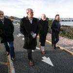 U.S. Rep. Rick Larsen (center left) walks near the intersection of Edmonds Street and Sunset Avenue with Phil Williams (left), City of Edmonds Public Works Director, as well as Edmonds Mayor Dave Earling (center right) and Edmonds&rsquo; economic development director Patrick Doherty (right) on Wednesday morning. A $24 million overpass has been proposed which would allow access to the Edmonds waterfront when trains are running. (Ian Terry / The Herald)