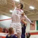 Stanwood&rsquo;s A.J. Martinka goes up for a dunk but is called for a charging foul with Lake Stevens&rsquo; Noah Wallace (14) and Wyatt Wahlberg (24) defending during a game Tuesday in Stanwood. (Andy Bronson / The Herald)