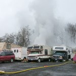 Officials are investigating what appears to be a makeshift trailer park in an industrial lot after a camper caught fire Monday morning near Lynnwood. (Rikki King / The Herald)