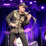 Geoffrey Castle plays his six-string electric violin in the 2015 version of Castle&rsquo;s Celtic Christmas Concert, which will be performed again on Saturday at the Historic Everett Theatre. His shirt and hat are hand-painted by his wife, Shannon Castle.