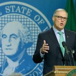 Washington Gov. Jay Inslee talks to reporters about his proposed budget on Wednesday in Olympia. (AP Photo/Ted S. Warren)
