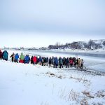 A procession makes its way down to the Cannonball River to take part in a Native American water ceremony at the Oceti Sakowin camp where people have gathered to protest the Dakota Access oil pipeline in Cannon Ball, North Dakota, on Friday, Dec. 2. (AP Photo/David Goldman)