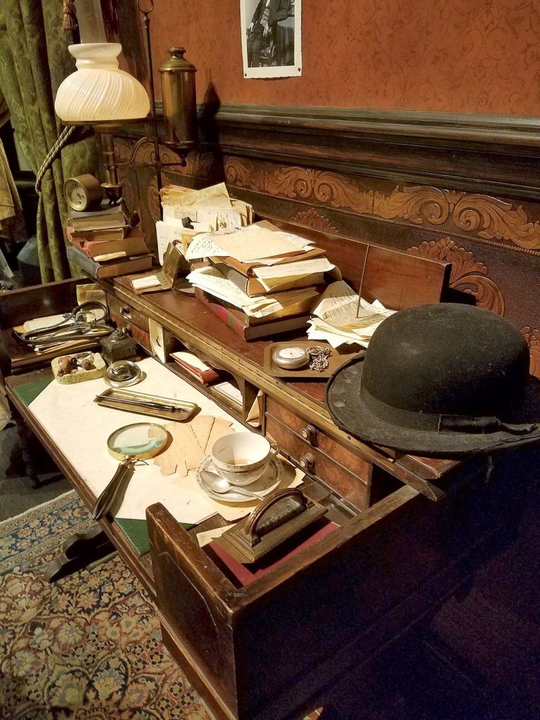 A desk in the &ldquo;study&rdquo; of Dr. Arthur Conan Doyle is crowded with research and notes. (Christina Okeson / The Herald)