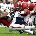 Alabama defensive linemen Jonathan Allen (93) and Brandon Ivory (99) tackle Chattanooga running back Kendrix Huitt (27) for a loss during the first half of a game Nov. 23 in Tuscaloosa, Ala. (AP Photo/Butch Dill)