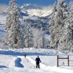 Cross-country ski areas in Winthrop enjoy sunny days and light powder snow. The trail system has wide, open landscapes and mountain scenery. (Photo courtesy of Methow Valley Photography)