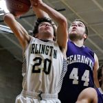 Arlington&rsquo;s Jaren Cary has his shot blocked and is fouled by Anacortes&rsquo; Jacob South Thursday night at Arlington High School on December 22, 2016. Anacortes won 79-53. (Kevin Clark / The Herald)