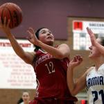 Stanwood&rsquo;s Kayla Frazier (left) attempts a shot with Kamiak&rsquo;s Kate Huguenin defending during the Mountlake Terrace Holiday Tournament Friday night at Mountlake Terrace High School. (Kevin Clark / The Herald)