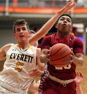 Cascade&rsquo;s D&rsquo;Andre Bryant attempts a shot with Everett&rsquo;s Byron Lewellen trailing during the annual Battle of Broadway Friday night at Everett Community College on December 2, 2016. (Kevin Clark / The Herald)
