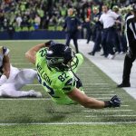 Seahawks tight end Luke Willson dives across the goal line for a touchdown with Rams Mike Jordan trailing at CenturyLink Field Thursday night in Seattle on December 15, 2016. (Kevin Clark / The Herald)