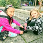 Brooklynn Little (right) is helped by Shoelace Brigade member EJ Yubal at Penny Creek Elementary School. (Contributed photo)