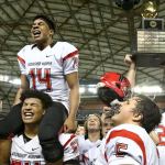 Archbishop Murphy&rsquo;s Anfernee Gurley (14) sits atop Jackson Yost&rsquo;s shoulders as teammates celebrate after the Wildcats beat Liberty 56-14 in the Class 2A state championship game Saturday afternoon at the Tacoma Dome. (Kevin Clark / The Herald)