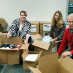 Mill Creek city employees Michelle Conner, Jody Gunderson and Spencer Moore package donations for shipping to Operation Gratitude. The city donation drive collected over 240 pounds of goods, enough to fill 10 boxes. (Contributed photo)