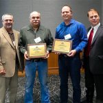 Washington Association of Conservation Districts President Mark Craven, left, and Executive Director Bob Schroeter, right, present Daryl Williams on behalf of Terry Williams and Tristan Klesick with the 2016 Vim Wright Building Bridges Award in Bellingham. (Contributed photo)