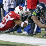 Seahawks wide receiver Paul Richardson dives for extra yardage with Cardinals corner back Brandon Williams defending Saturday afternoon at CenturyLink Field in Seattle on December 24, 2016. The Cardinals won 34-31. (Kevin Clark / The Herald)