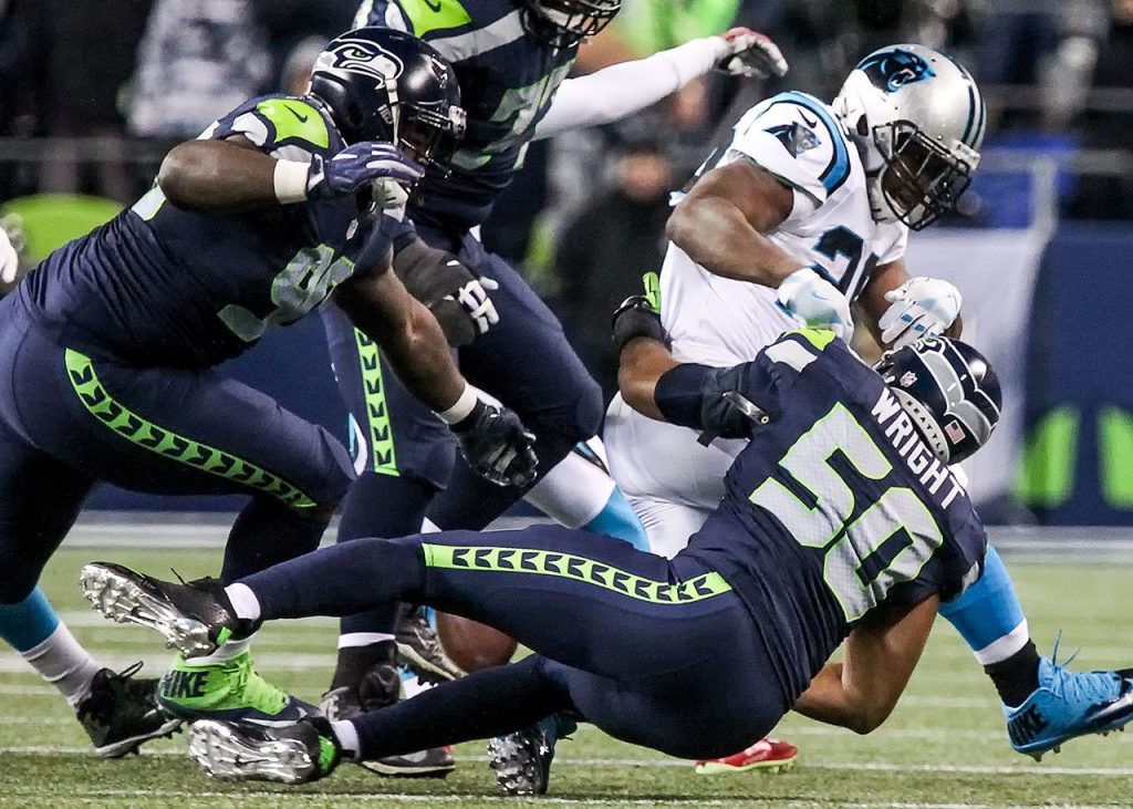 Seahawks linebacker K.J. Wright forces a fumble by Panthers running back Jonathan Stewart Sunday night at CenturyLink Field in Seattle on December 4, 2016. (Kevin Clark / The Herald)