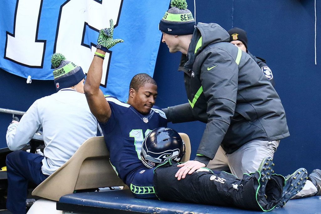 Seahawks wide receiver Tyler Lockett is carted off the field with a season ending injury Saturday afternoon at CenturyLink Field in Seattle on December 24, 2016. The Cardinals won 34-31. (Kevin Clark / The Herald)