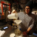 Old Ballard Liquor Co.&rsquo;s Jane Frazee pours vodka through an infuser filled with cloves at the distillery, located just a few blocks east of the Ballard bridge&rsquo;s north side, on Thursday, Dec. 8. (Ian Terry / The Herald)