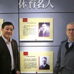 William McCloy (right), of Edmonds, stands near a wall at the national Southeast University in China. It includes a commemoration of his grandfather, the late Charles Harold McCloy, who taught in China in the early 20th century. (Courtesy of William McCloy)