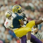 Washington&rsquo;s Walter Bailey (rear) intercepts a pass intended for Michigan&rsquo;s Desmond Howard (21) in the first quarter of the Rose Bowl on Jan. 1, 1992, in Pasadena, Calif. Washington won the game 34-14 (AP Photo/Bob Galbraith)
