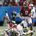 Alabama running back Bo Scarbrough (9) runs the ball past Washington&rsquo; Ben Burr-Kirven (25) and Taylor Rapp en route to a touchdown during the second half of the Peach Bowl on Saturday in Atlanta. (AP Photo/Skip Martin)