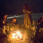 Phillip Swafford, from left, and David Cook, both of Colorado, sit around a campfire at the Oceti Sakowin camp where thousands have gathered to protest the Dakota Access oil pipeline near Cannon Ball, North Dakota, on Wednesday, Nov. 30. The pipeline is designed to carry oil from North Dakota to Illinois. Opponents, including the Standing Rock Sioux tribe, say it will harm drinking water and cultural sites. (AP Photo/David Goldman)