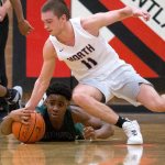 Edmonds-Woodway&rsquo;s Uchenna Acholonu grabs the loose ball as North Kitsap&rsquo;s Jake Houghton reaches down as Edmonds-Woodway lost to North Kitsap 68-62 at the 2016 Mountlake Terrace Boys Varsity Basketball Tournament on Tuesday, Dec. 27, 2016 in Mountlake Terrace, Wa. (Andy Bronson / The Herald)