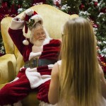 Tom LaBelle lifts his red hat to 4-year-old Kloe Gregory as she tells him about her Christmas plans in the Everett Mall on Monday, Nov. 28. (Daniella Beccaria / The Herald)