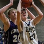 Arlington&rsquo;s Drew Bryson attempts a shot with Anacortes&rsquo; Jesse Keltner defending, left, Thursday night at Arlington High School on December 22, 2016. Anacortes won 79-53. (Kevin Clark / The Herald)