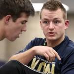 New Arlington wrestling coach Jonny Gilbertson demonstrates on Will Rush during practice Wednesday. (Kevin Clark/The Herald)
