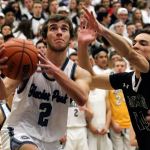 Glacier Peak&rsquo;s Austin Petz drives the baseline with Jackson&rsquo;s Paul Doney defending during a game Friday at Glacier Peak High School in Snohomish. The Grizzles defeated the Timberwolves 64-41. (Kevin Clark / The Herald)