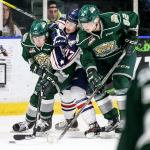 The Silvertips&rsquo; Connor Dewar (left) and Eetu Tuulola (far right) squeeze out the Americans&rsquo; Carson Focht for control of the puck Wednesday night at Xfinity Arena in Everett. (Kevin Clark / The Herald)