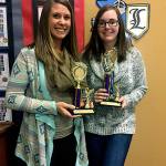 Lowell Elementary School teachers Cristie Smith and Amber McPartland display trophies their school won in an Everett Elks Lodge 479 contest to see which school could donate the most stuffed toys and children&rsquo;s books for Christmas House. Lowell took first place for books and second place for toys. (Contributed photo)