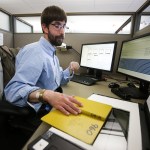 James Oliver scans field books with notes taken by Snohomish county workers at his desk in Everett on Nov. 2. Oliver spends much of his day meticulously archiving historic copies of the field books, which date back to the late 1800s. (Ian Terry / The Herald)