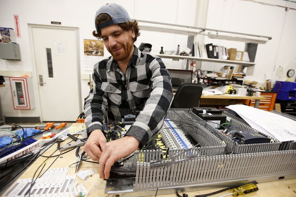 Donnie Connor, an electrician, works on an electrical panel to be installed inside one of the company&rsquo;s vanadium batteries. (Ian Terry / The Herald)