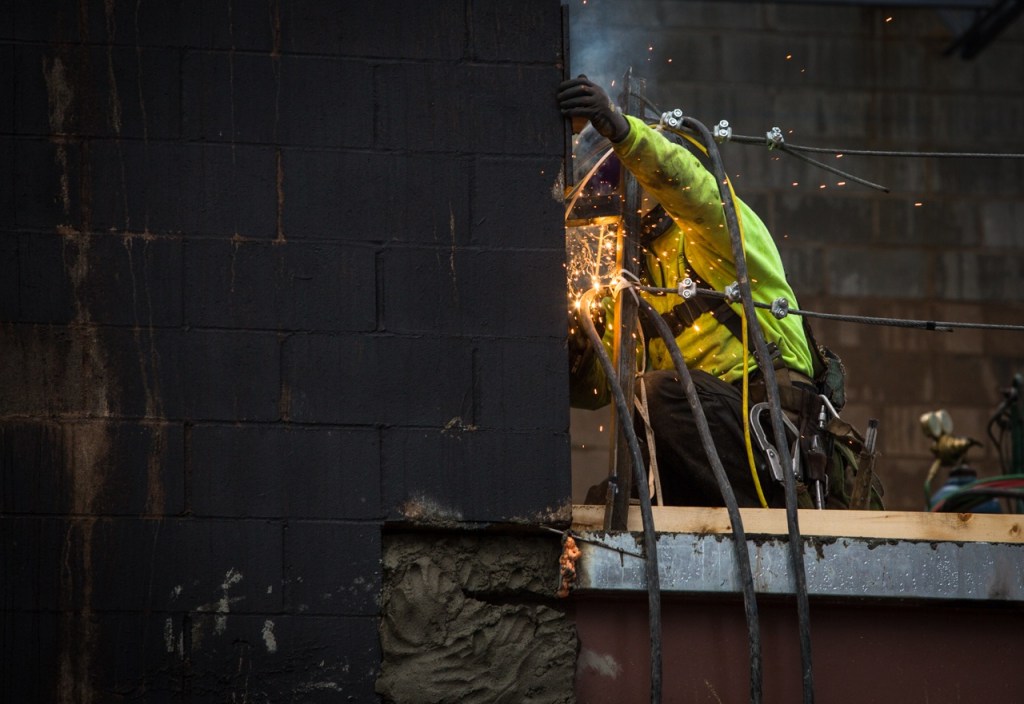 A crew member works on the second floor of the new Park Place Middle School on Monday in Monroe. The project is in Phase One with reconstruction of classrooms, fields, gymnasium and a cafeteria set to be completed by 2018. (Daniella Beccaria / The Herald)