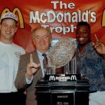 University of Washington coach Don James (center), quarterback Billy Joe Hobert (left) and running back Beno Bryant accept the McDonald&rsquo;s Trophy on Jan. 2, 1992 in Anaheim, Calif. After beating Michigan in the Rose Bowl 34-14, the Huskies were chosen No.1 in the USA Today-CNN coaches poll, but sportswriters picked Miami as the national champion in the AP poll. (AP Photo/Nick Ut)