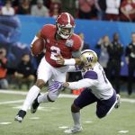 Alabama quarterback Jalen Hurts (2) is tackled by Washington defensive back Jojo McIntosh (14) during the first half of the Peach Bowl on Saturday in Atlanta. (AP Photo/David Goldman)