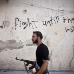 A Free Syrian Army soldier walks through a street in Amariya district in Aleppo, Syria, on Sept. 10, 2012. (AP Photo/Manu Brabo, File)