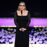 In this Jan. 25, 2015 photo, Carrie Fisher presents the life achievement award on stage at the 21st annual Screen Actors Guild Awards at the Shrine Auditorium in Los Angeles. (Photo by Vince Bucci/Invision/AP, File)