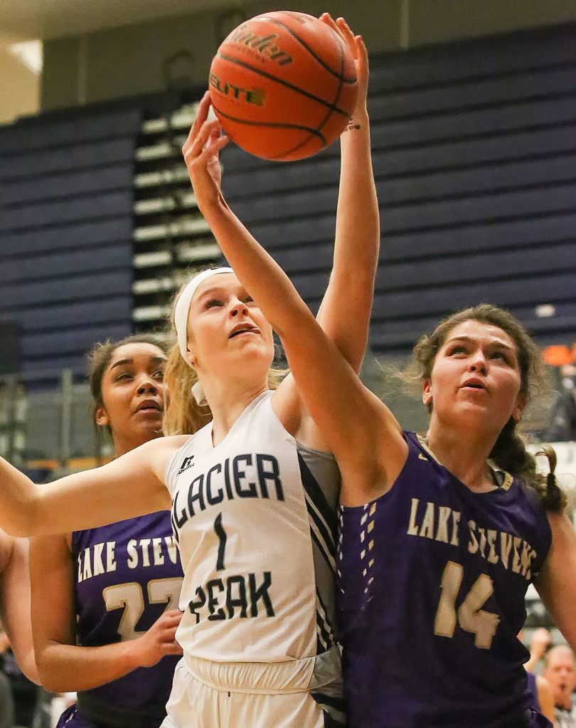 Glacier Peak&rsquo;s Haley Grambo (left) and Lake Stevens&rsquo; Taylor Smith vie for control of a rebound Wednesday night at Glacier Peak High School in Snohomish. (Kevin Clark / The Herald)