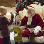 Riley Piper, 7, high-fives Santa Claus in the Everett Mall on Monday, Nov. 28. (Daniella Beccaria / The Herald)