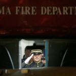A law enforcement officer salutes as viewed through the windshield of a Tacoma Fire Department ambulance as the body of officer Reginald &ldquo;Jake&rdquo; Gutierrez is placed in the vehicle for a procession away from Tacoma General Hospital, in Tacoma. (AP Photo/Ted S. Warren)
