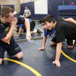 New Arlington wrestling coach Jonny Gilbertson instructs Pedro Sanchez (center) and Patrick Connelly during practice Wednesday. (Kevin Clark/The Herald)