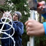 Doug Wightman assembles decorations at Warm Beach Lights of Christmas on November 17. (Kevin Clark / The Herald)