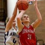 Kamiak&rsquo;s Alexie Morris blocks and fouls Stanwood&rsquo;s Jillian Heichel&rsquo;s shot attempt during the Mountlake Terrace Holiday Tournament Friday night at Mountlake Terrace High School. (Kevin Clark / The Herald)