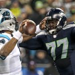 Panthers quarterback Cam Newton attempts to avoid a pass rush by Seahawks defensive lineman Ahtyba Rubin Sunday night at CenturyLink Field in Seattle on December 4, 2016.(Kevin Clark / The Herald)